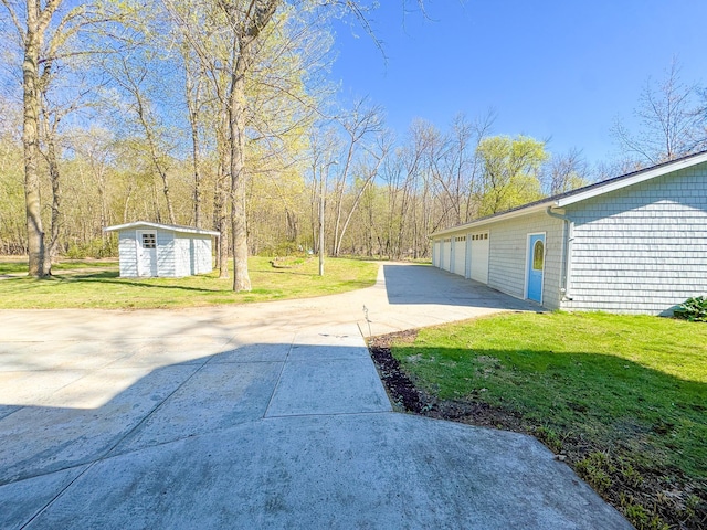 49262 Big Pine Rd, Perham, MN 56573 - view of grassy yard with an outbuilding, driveway, a shed, and a garage