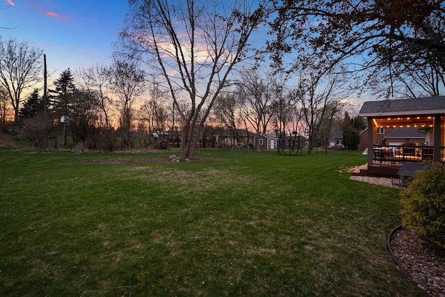 view of grassy yard with a deck