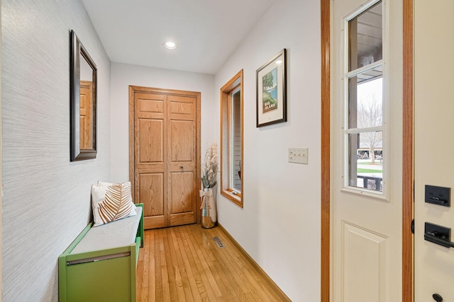 corridor featuring light wood-style floors and recessed lighting