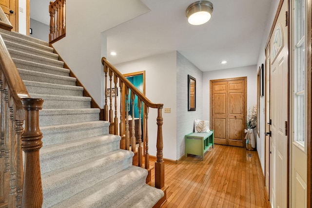 entryway with stairs, light wood-style floors, recessed lighting, and baseboards