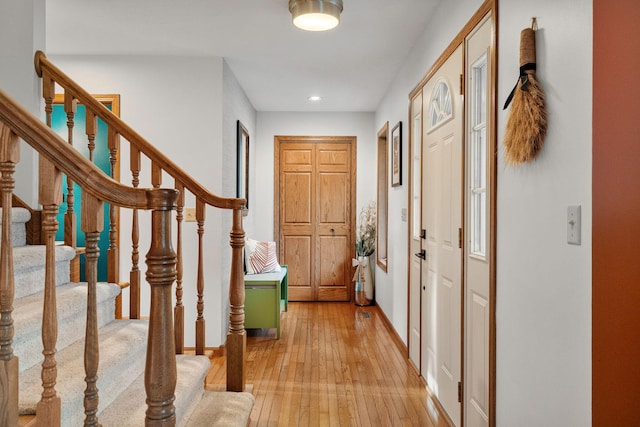 entrance foyer with light wood-type flooring, stairway, recessed lighting, and baseboards