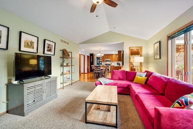 living area with a chandelier, carpet, ceiling fan, vaulted ceiling, and baseboards