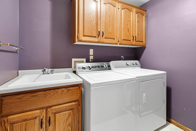 clothes washing area with independent washer and dryer and cabinet space