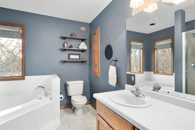 bathroom with toilet, tile patterned flooring, vanity, a garden tub, and baseboards