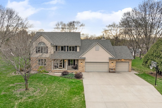 view of front of property featuring a porch, an attached garage, a front yard, and driveway