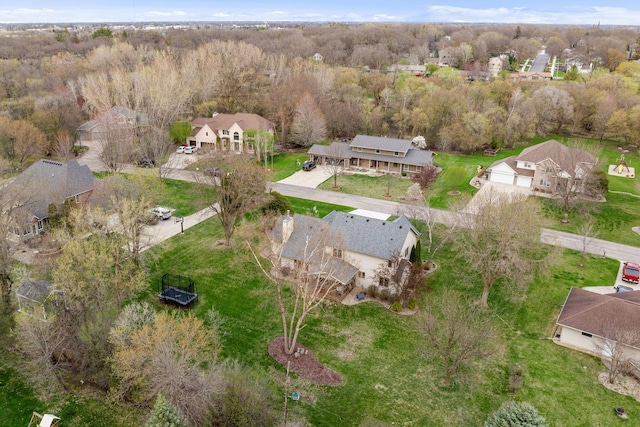 aerial view of property's location with a heavily wooded area and nearby suburban area