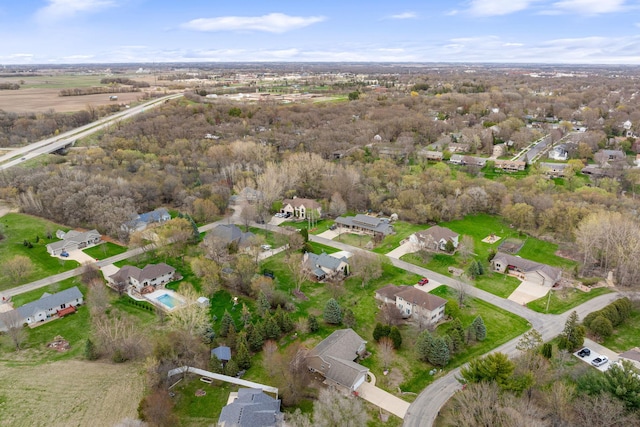 aerial view of property and surrounding area featuring nearby suburban area