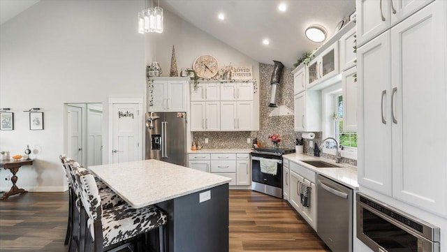 12911 Turtle Lake Ct SW, Lake Mary Twp, MN 56308 - kitchen with appliances with stainless steel finishes, a sink, wall chimney exhaust hood, dark wood finished floors, and a kitchen breakfast bar