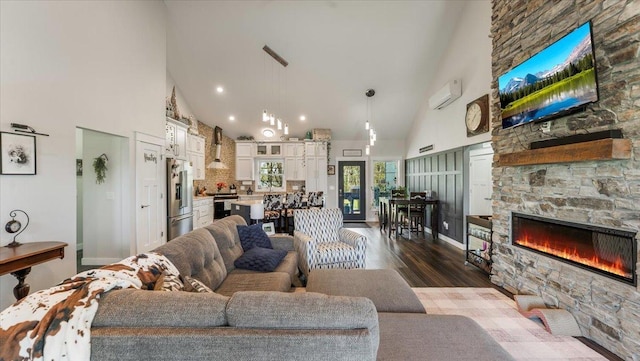 12911 Turtle Lake Ct SW, Lake Mary Twp, MN 56308 - living area featuring high vaulted ceiling, wood finished floors, a stone fireplace, and recessed lighting
