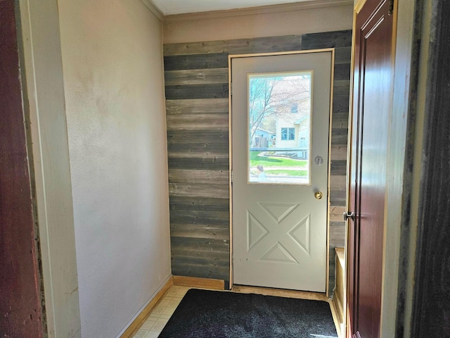 entryway with wooden walls and crown molding