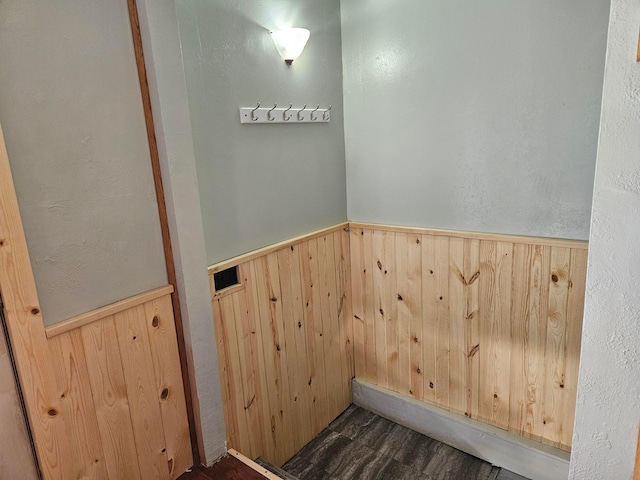 laundry area with wooden walls and wainscoting