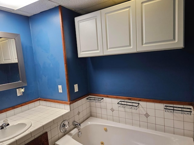full bathroom featuring a sink and a tub with jets