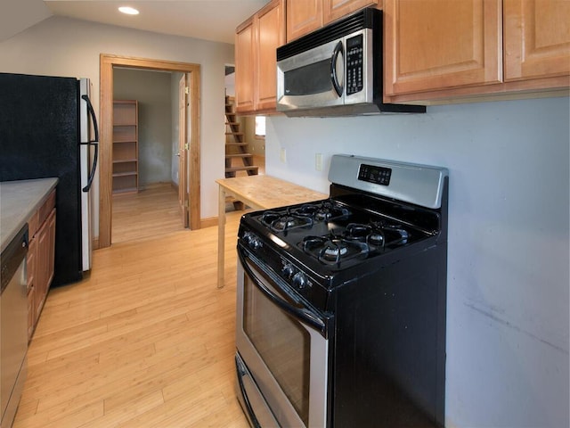 kitchen featuring appliances with stainless steel finishes, light wood finished floors, recessed lighting, and light countertops