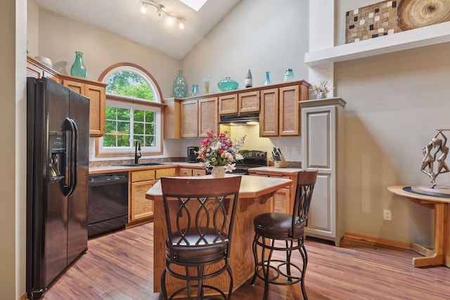 5662 Donegal Dr, Shoreview, MN 55126 - kitchen featuring high vaulted ceiling, black appliances, a breakfast bar area, light wood-type flooring, and a center island