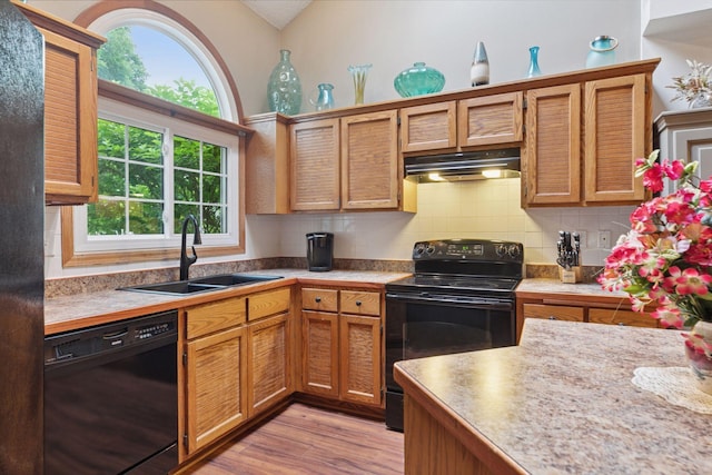 5662 Donegal Dr, Shoreview, MN 55126 - kitchen with black appliances, healthy amount of natural light, backsplash, under cabinet range hood, and lofted ceiling