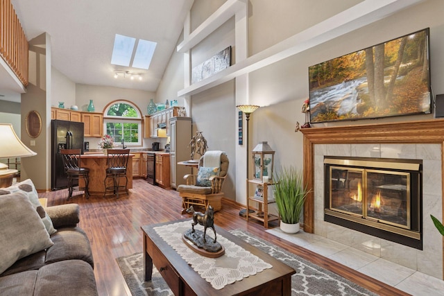 5662 Donegal Dr, Shoreview, MN 55126 - living room with a skylight, high vaulted ceiling, wood finished floors, and a fireplace