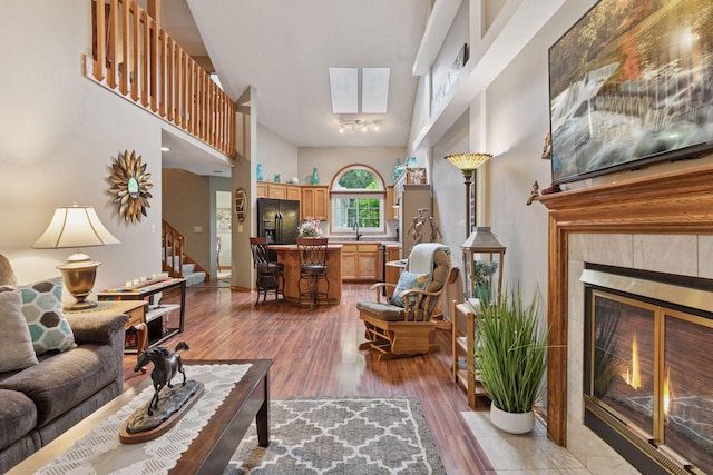 5662 Donegal Dr, Shoreview, MN 55126 - living room with stairs, a tile fireplace, wood finished floors, and a high ceiling