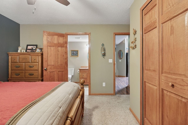 5662 Donegal Dr, Shoreview, MN 55126 - bedroom with light colored carpet, connected bathroom, a textured ceiling, and ceiling fan