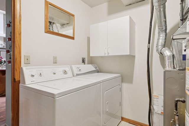 5662 Donegal Dr, Shoreview, MN 55126 - laundry room with independent washer and dryer, cabinet space, and heating unit