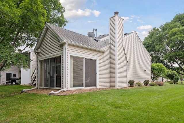 5662 Donegal Dr, Shoreview, MN 55126 - back of house featuring a yard, a chimney, and a shingled roof
