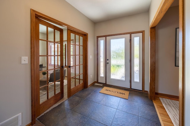 doorway to outside with french doors and baseboards