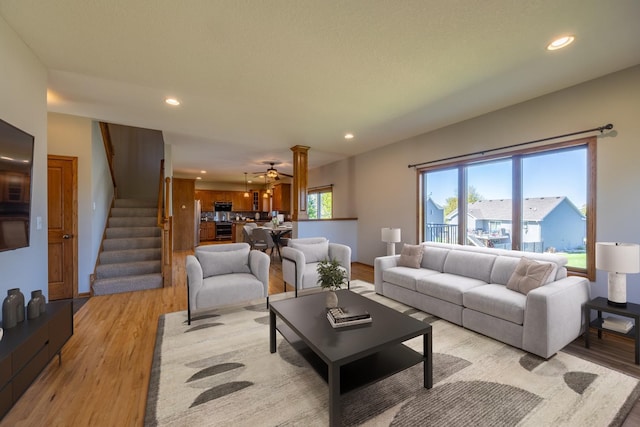 living room featuring recessed lighting, stairs, light wood-type flooring, and a ceiling fan