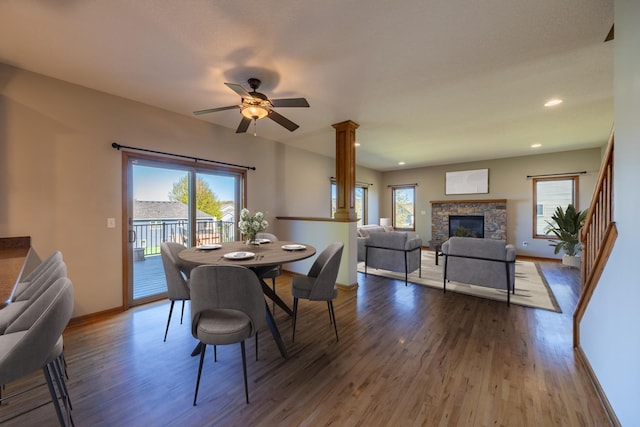 dining room featuring baseboards, plenty of natural light, wood finished floors, and recessed lighting