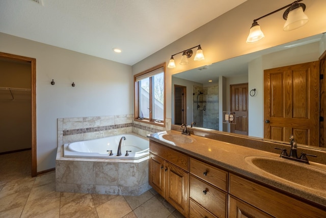 bathroom with a stall shower, a garden tub, tile patterned flooring, a spacious closet, and double vanity
