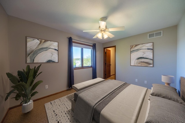 bedroom featuring baseboards, light colored carpet, and a ceiling fan