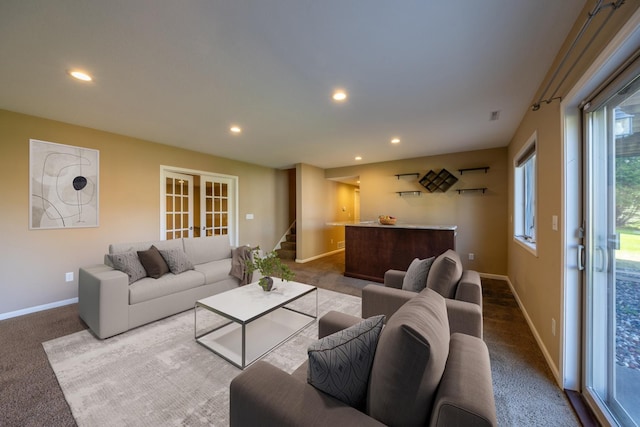 carpeted living area with stairs, healthy amount of natural light, recessed lighting, and baseboards
