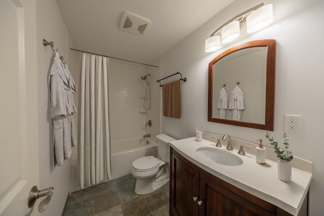 full bathroom featuring toilet, vanity, shower / bath combo, and stone finish floors