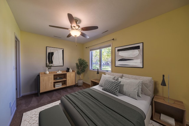 bedroom with dark carpet, baseboards, and a ceiling fan