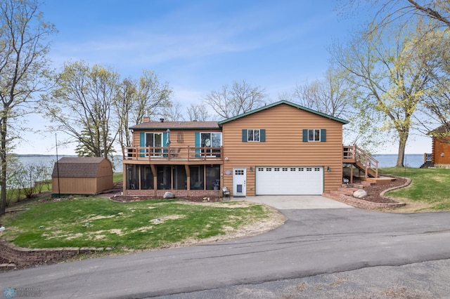 24295 Matson Point Trl, Lida Twp, MN 56572 - view of front of house with a storage unit, stairs, driveway, a garage, and an outbuilding