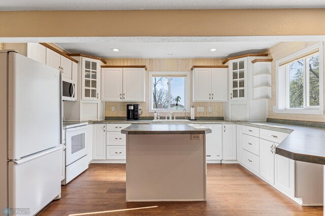 24295 Matson Point Trl, Lida Twp, MN 56572 - kitchen with white appliances, healthy amount of natural light, wood finished floors, a center island, and recessed lighting