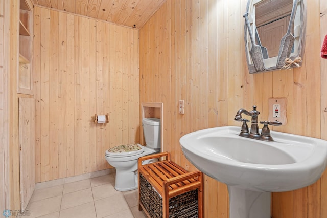 24295 Matson Point Trl, Lida Twp, MN 56572 - bathroom with wooden walls, toilet, tile patterned flooring, a sink, and wooden ceiling