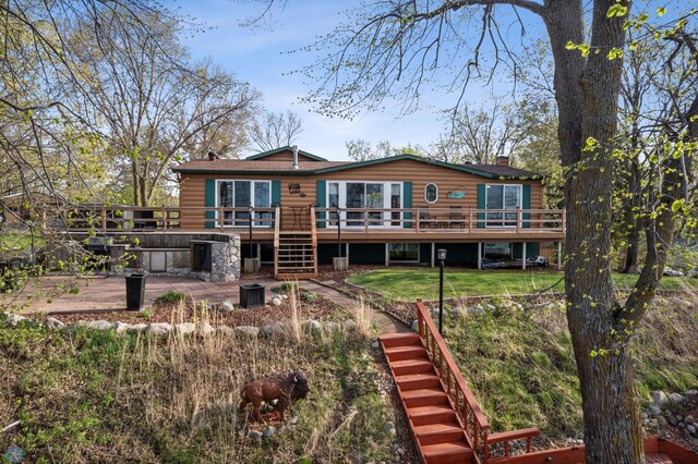 24295 Matson Point Trl, Lida Twp, MN 56572 - rear view of house with stairway, faux log siding, a wooden deck, and a lawn