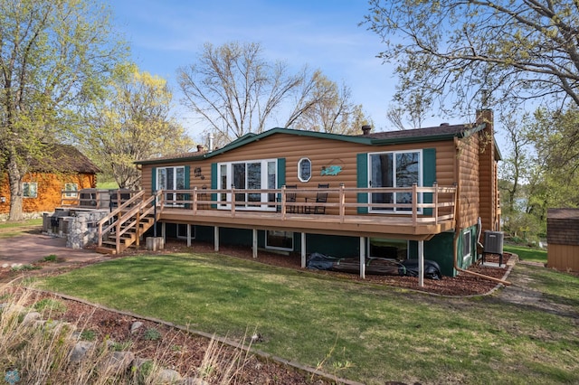 24295 Matson Point Trl, Lida Twp, MN 56572 - back of property featuring a wooden deck, a chimney, a lawn, and central AC