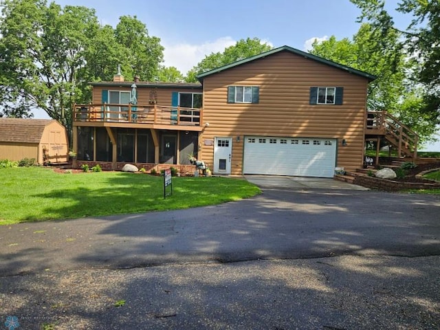 24295 Matson Point Trl, Lida Twp, MN 56572 - view of front of property featuring an attached garage, asphalt driveway, a storage shed, a front lawn, and stairs