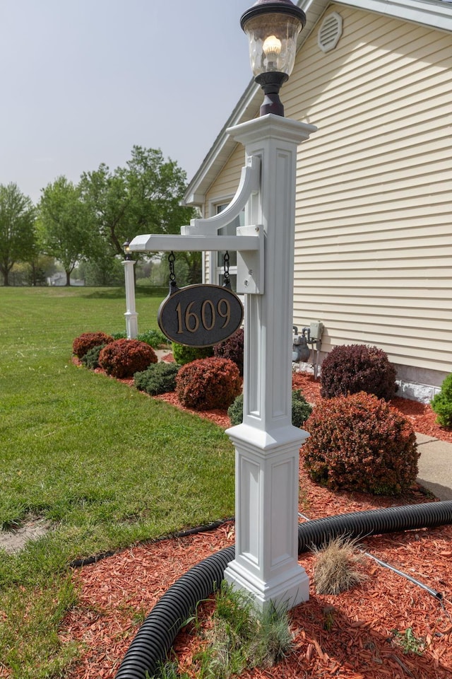 community / neighborhood sign with a lawn