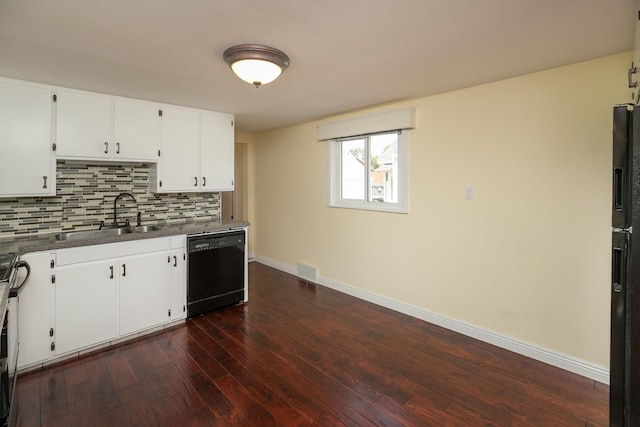 kitchen featuring black dishwasher, a sink, baseboards, dark wood-type flooring, and tasteful backsplash