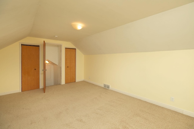 bonus room featuring carpet floors, vaulted ceiling, and baseboards