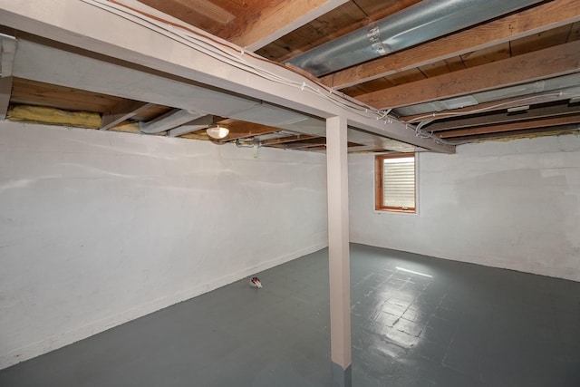 below grade area featuring tile patterned floors and baseboards
