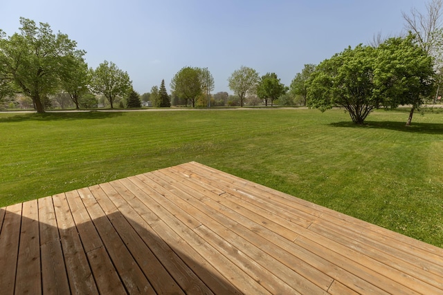 wooden deck with a lawn