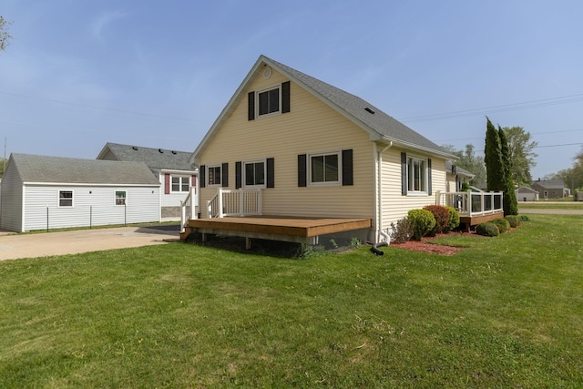 rear view of property with a deck and a yard