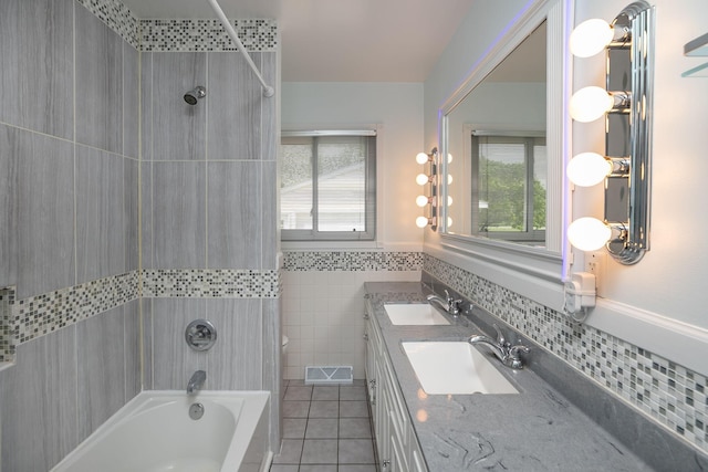 1609 1st Ave NE, Austin, MN 55912 - full bathroom featuring tile patterned floors, bathing tub / shower combination, double vanity, and tile walls
