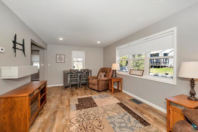sitting room with light wood-style floors, baseboards, and recessed lighting