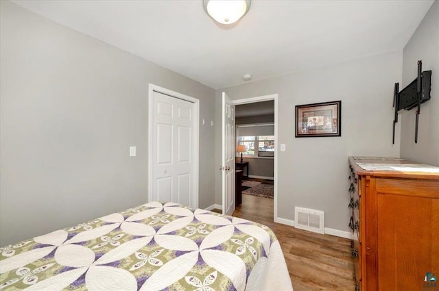 bedroom featuring wood finished floors and baseboards
