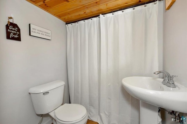 full bath with toilet, a sink, and wooden ceiling