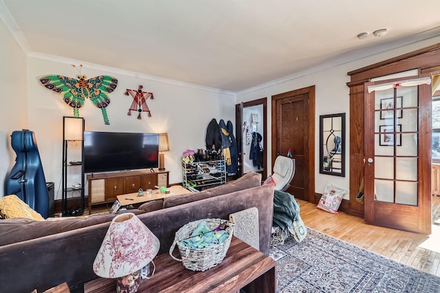 living room with light wood-style floors and crown molding
