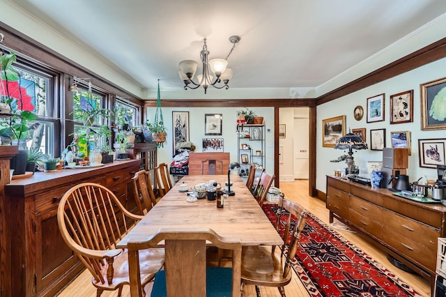 dining room featuring light wood-style flooring and a chandelier